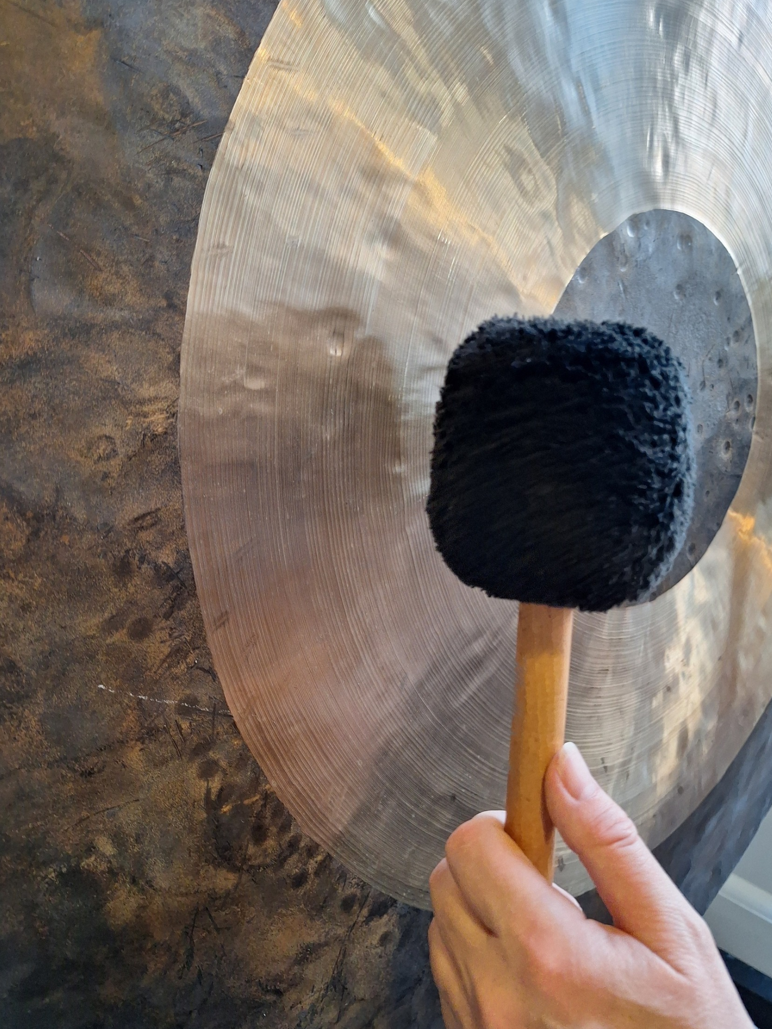 Gong and beater used in sound therapy sessions